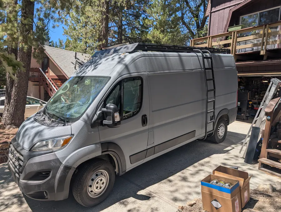 Bedliner-coated ProMaster with roof rack and rear ladder — Big Bear Camper Vans build