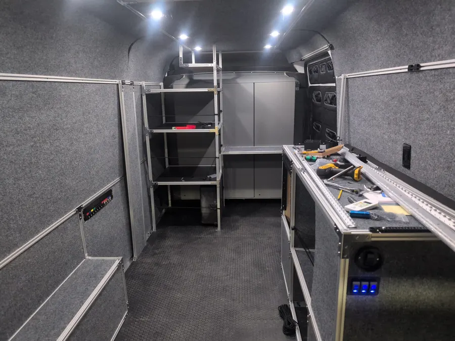 Equipment van interior with 80/20 shelving and workbench — Big Bear Camper Vans build