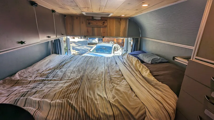Cedar-lined ceiling over the rear sleeping platform — Big Bear Camper Vans build