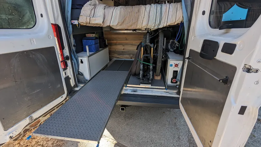 Rear slide-out ramp with under-bed bike storage — Big Bear Camper Vans build